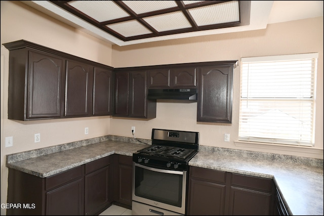 kitchen featuring gas range and dark brown cabinetry