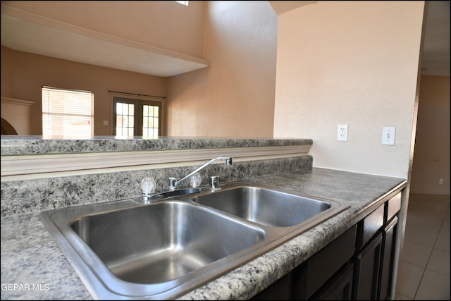 kitchen featuring sink, french doors, and tile patterned floors