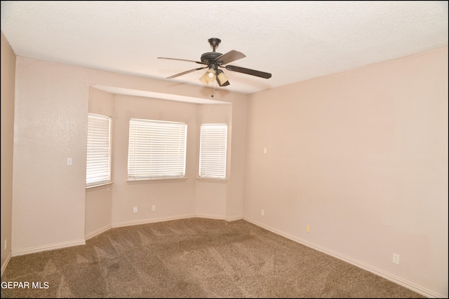 carpeted empty room with a textured ceiling and ceiling fan