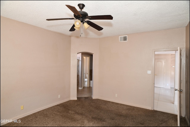 carpeted empty room featuring a textured ceiling and ceiling fan