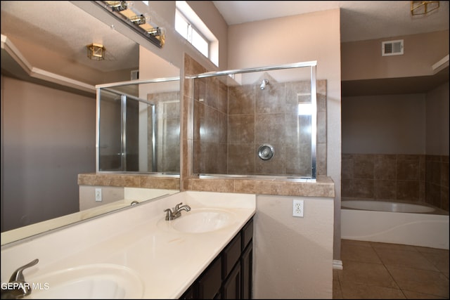 bathroom with dual vanity, independent shower and bath, a textured ceiling, and tile patterned floors