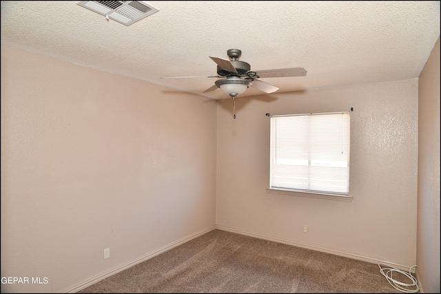 empty room featuring carpet flooring, a textured ceiling, and ceiling fan