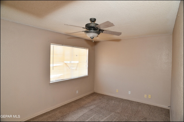 carpeted spare room featuring a textured ceiling and ceiling fan