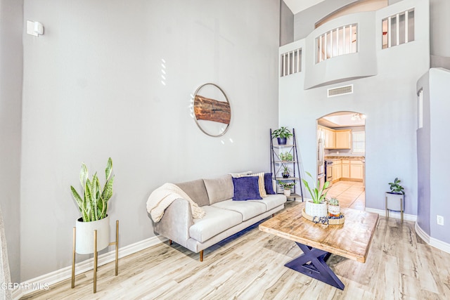 living room featuring a high ceiling and hardwood / wood-style flooring