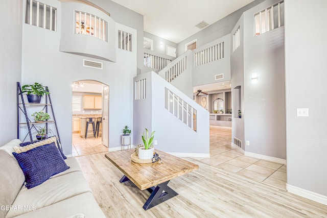 living room with light tile patterned flooring and a high ceiling