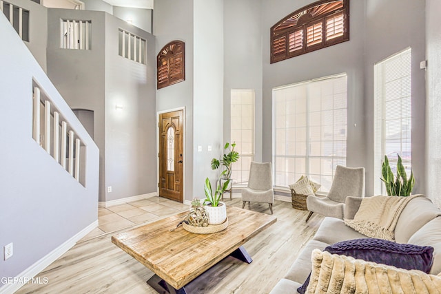 interior space featuring light hardwood / wood-style flooring and a high ceiling