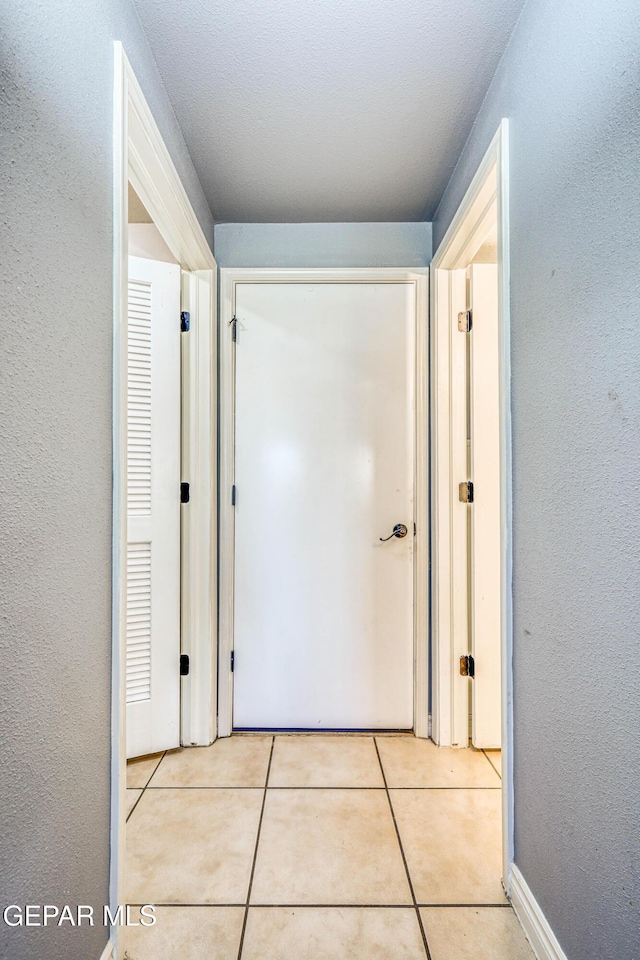 hallway featuring light tile patterned floors