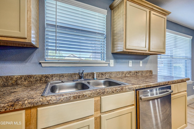 kitchen featuring dishwasher, light tile patterned floors, and sink