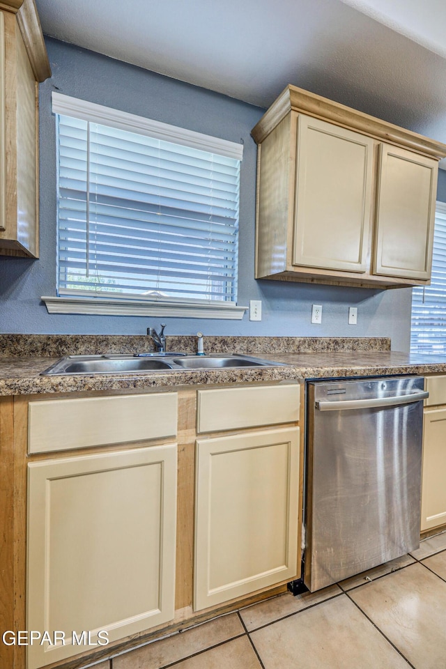 kitchen featuring dishwasher, light tile patterned flooring, and cream cabinets