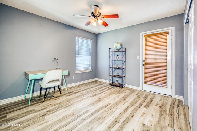 office with ceiling fan and light hardwood / wood-style floors