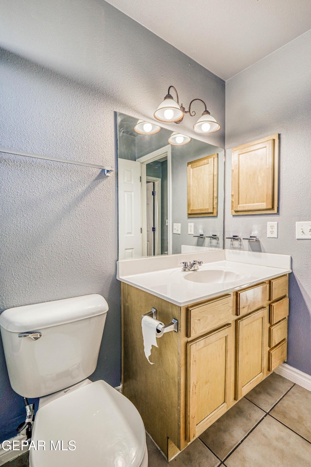 bathroom with tile patterned floors, vanity, and toilet