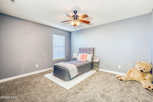 bedroom featuring ceiling fan and carpet