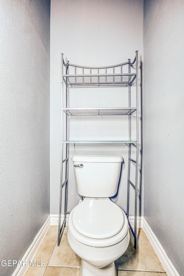 bathroom with tile patterned flooring and toilet