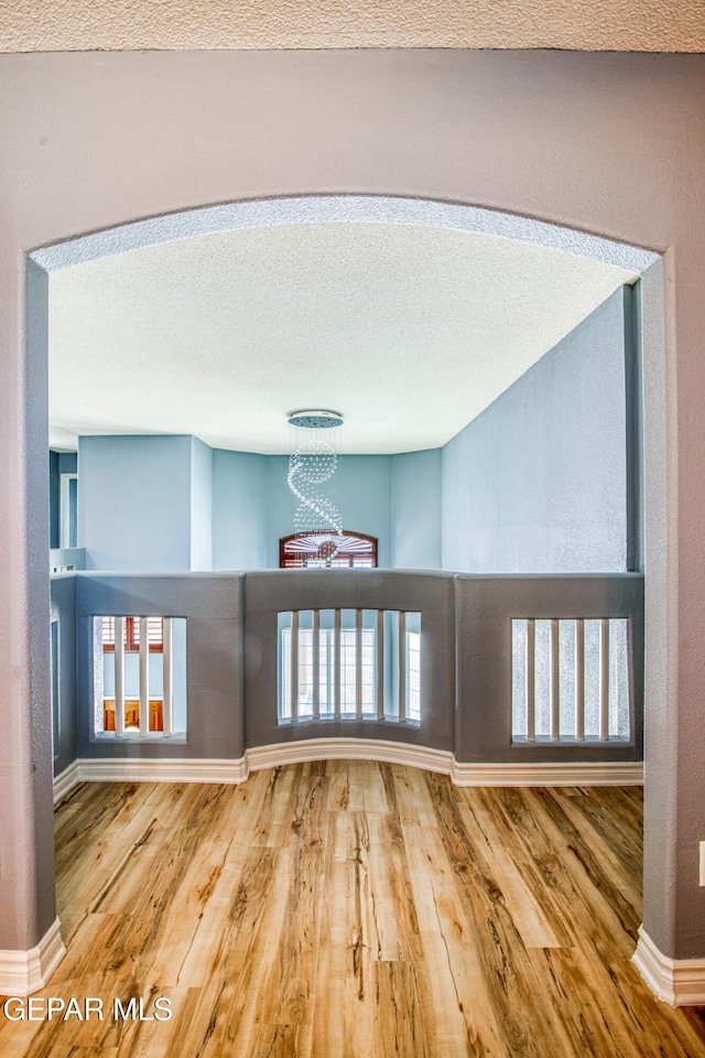 interior space featuring a chandelier, a textured ceiling, and hardwood / wood-style flooring