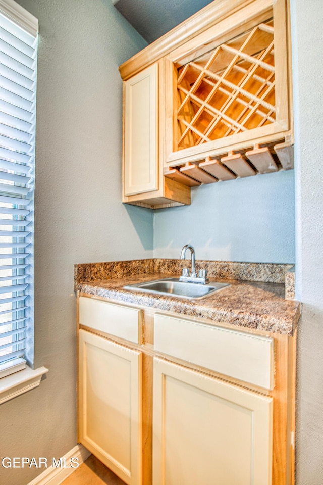 kitchen featuring sink and cream cabinetry