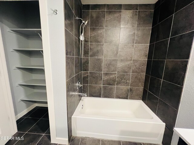 bathroom featuring tiled shower / bath combo and tile patterned flooring