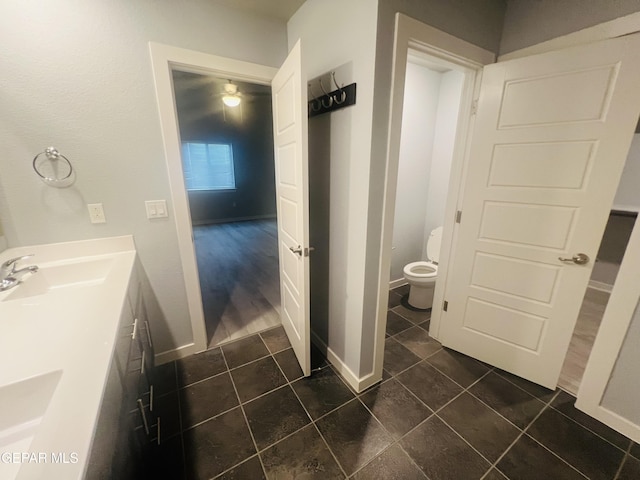 bathroom with sink, toilet, and tile patterned floors