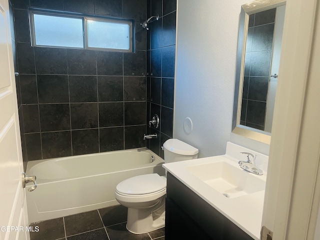 full bathroom with tiled shower / bath combo, toilet, tile patterned floors, and vanity