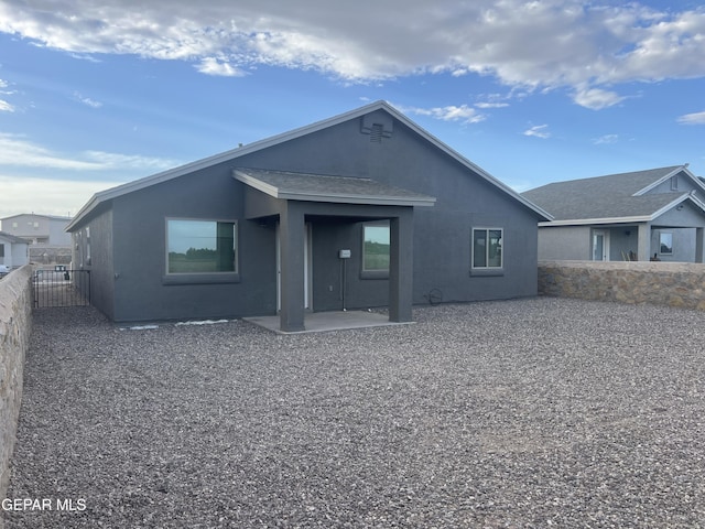 back of house with a patio