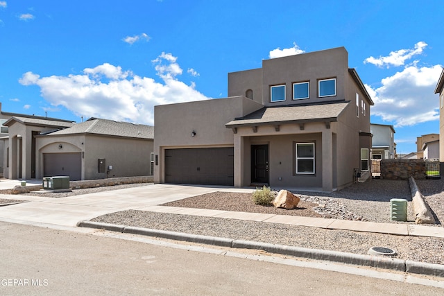 adobe home with a garage and central air condition unit