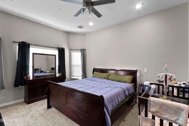 bedroom featuring ceiling fan and light carpet