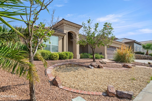 view of front of home featuring a garage and stucco siding