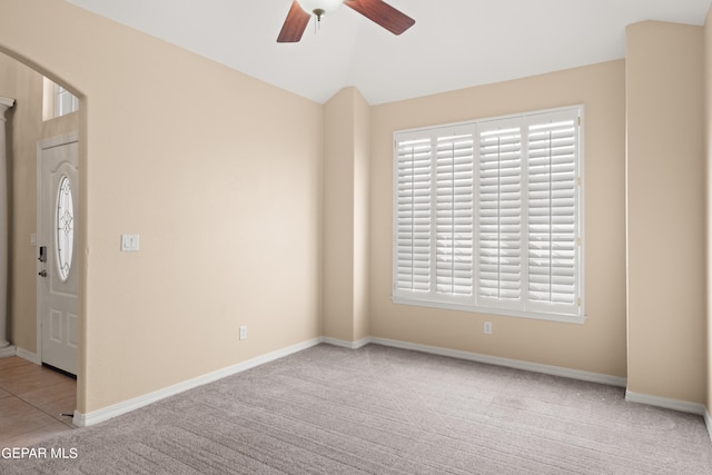 spare room with light colored carpet and ceiling fan