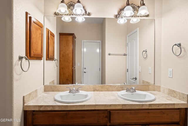 bathroom featuring a notable chandelier and double sink vanity