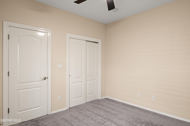 unfurnished bedroom featuring ceiling fan, carpet flooring, and a closet