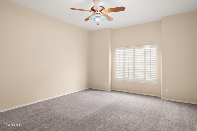 carpeted spare room with ceiling fan