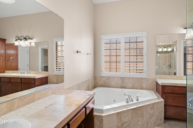 bathroom with tile patterned flooring, separate shower and tub, vanity, and a high ceiling