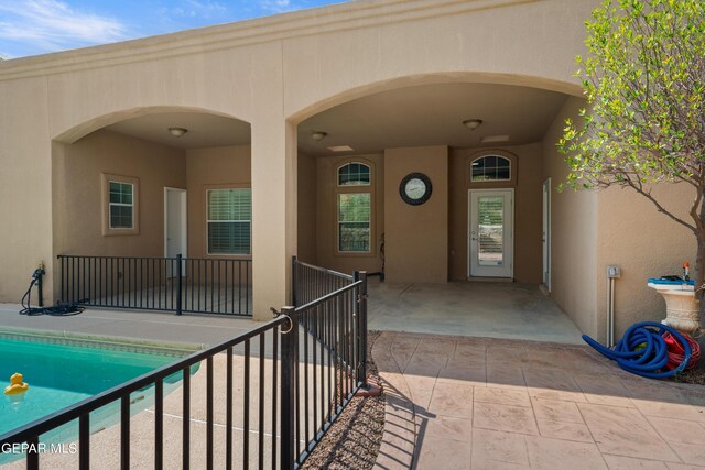 doorway to property with a patio area and a fenced in pool