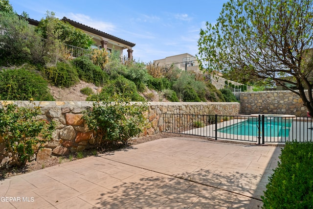 view of patio with a fenced in pool