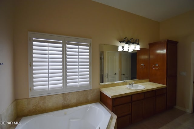 bathroom featuring a wealth of natural light, vanity, tiled tub, and tile patterned floors