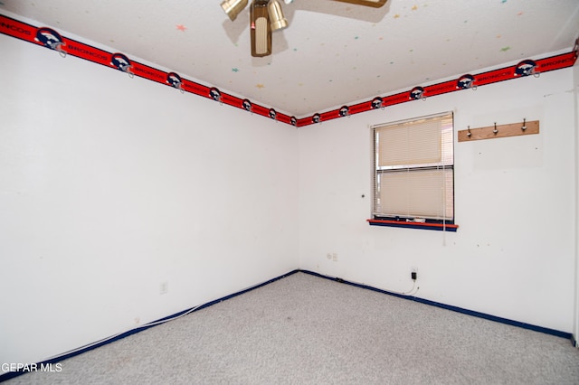 empty room featuring light colored carpet and ceiling fan