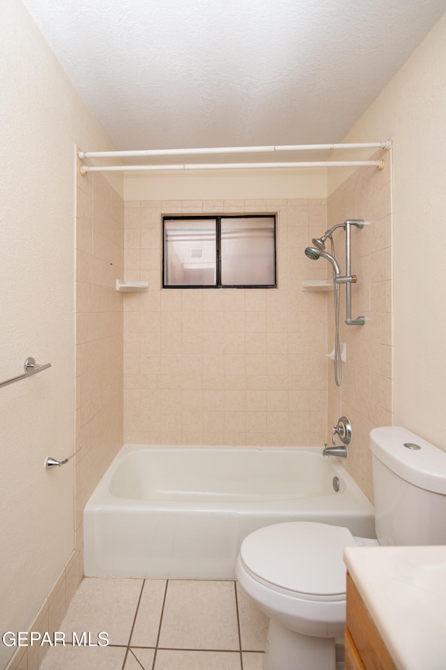 full bathroom with vanity, tile patterned flooring, toilet, and tiled shower / bath combo