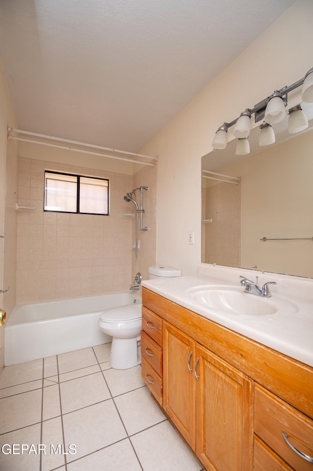 full bathroom with toilet, vanity, tiled shower / bath combo, and tile patterned floors