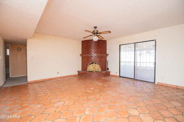 unfurnished living room with a textured ceiling, ceiling fan, and a fireplace