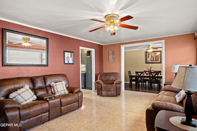 tiled living room featuring ceiling fan