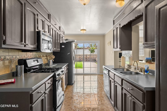 kitchen with tasteful backsplash, stainless steel appliances, sink, dark brown cabinetry, and light tile patterned floors