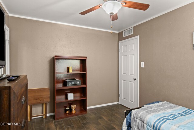 bedroom with crown molding, dark hardwood / wood-style floors, and ceiling fan