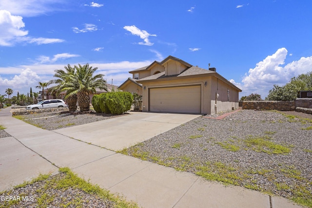 view of front of property with stucco siding, concrete driveway, and a garage