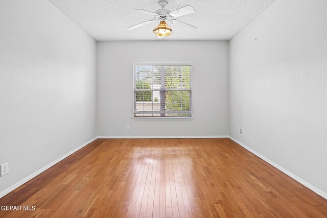 unfurnished room featuring a textured ceiling, ceiling fan, and light hardwood / wood-style floors