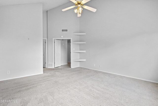 unfurnished room featuring ceiling fan, built in shelves, high vaulted ceiling, and light carpet