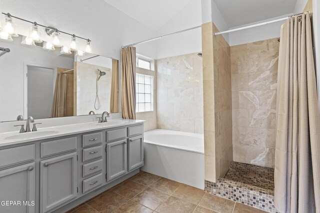 bathroom with plus walk in shower, tile patterned flooring, vaulted ceiling, and vanity