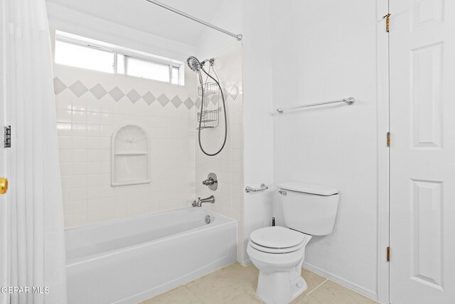 bathroom with toilet, tiled shower / bath combo, and tile patterned floors