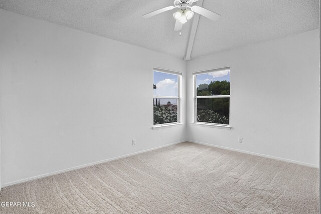 spare room featuring ceiling fan, a textured ceiling, vaulted ceiling with beams, and carpet flooring