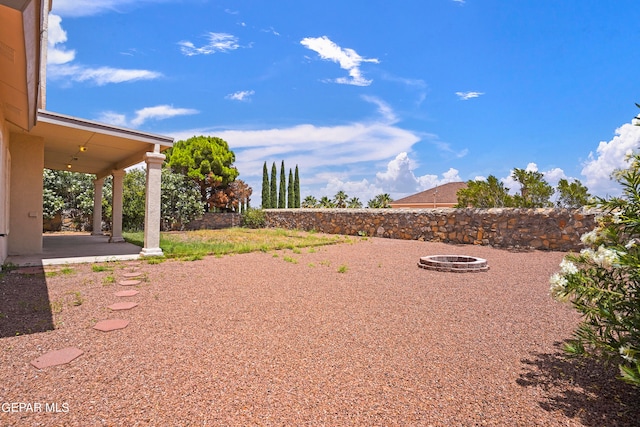 view of yard with a patio and a fire pit