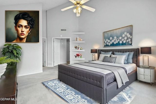 carpeted bedroom with ceiling fan and high vaulted ceiling