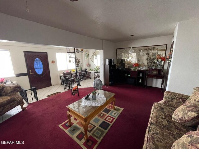 carpeted living room featuring a textured ceiling